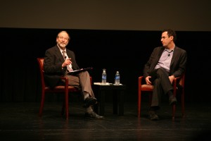 Two men are talking in Tony Kushner and Meeropol Talk Show
